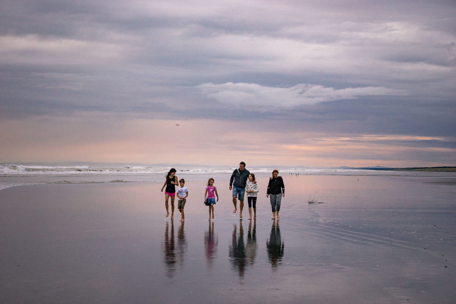 Family walking at Himatangi Beach