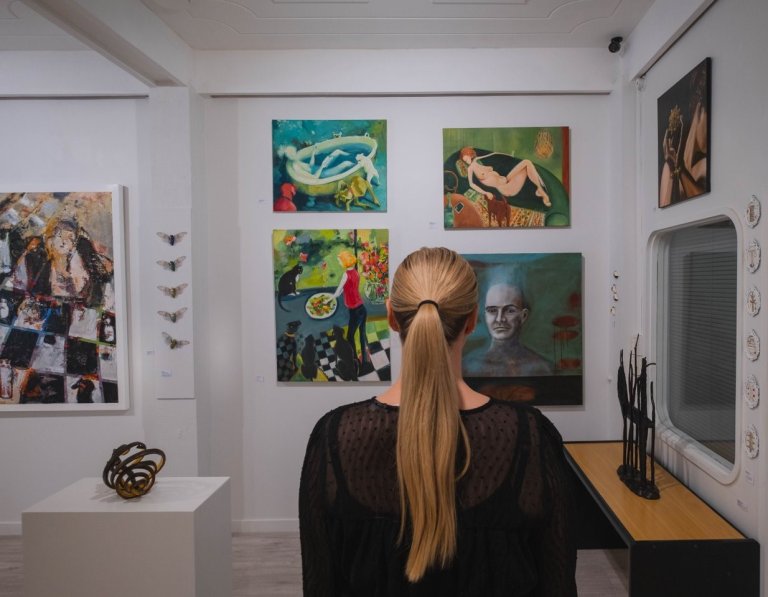 Woman looking at paintings at Zimmerman Gallery in Palmerston North & Manawatu