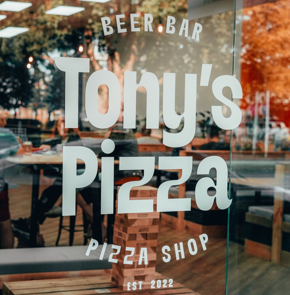 Shopfront window branding at Tony's Pizza